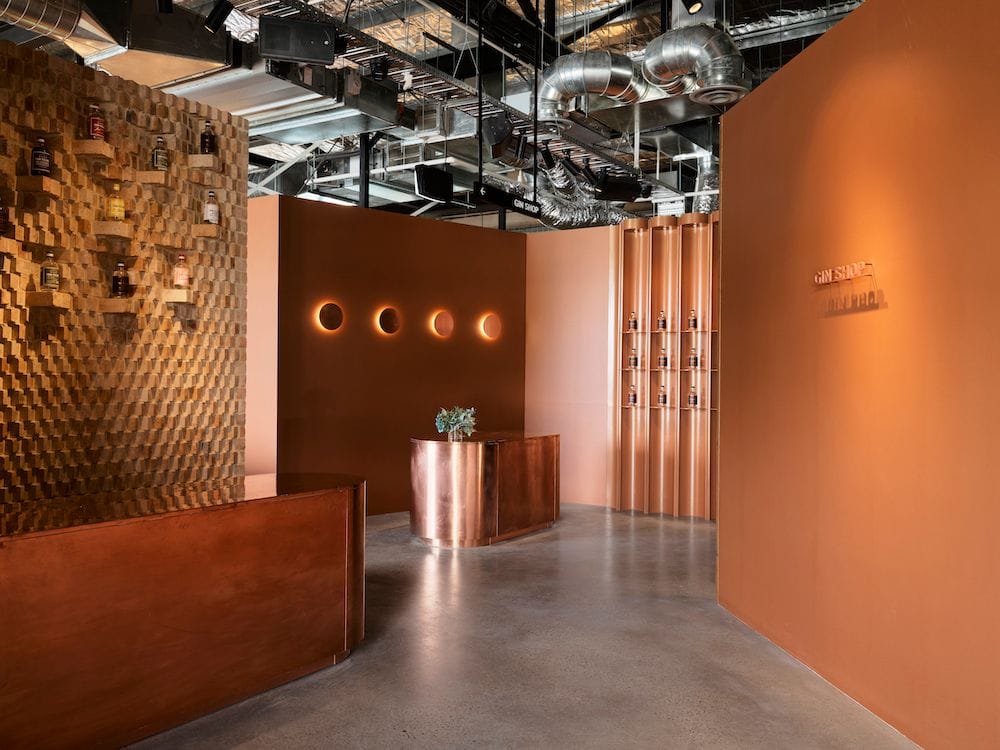 Pill-shaped copper welcome desk and Four Pillars ‘dots’