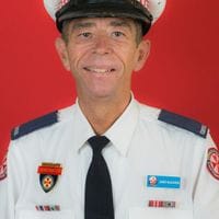 Ambulance officer headshot red background