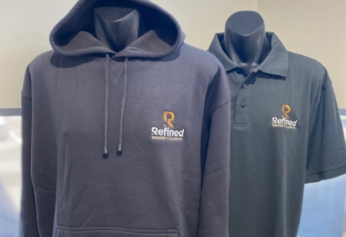 Grey hoodie and polo shirt branded with tradie logo