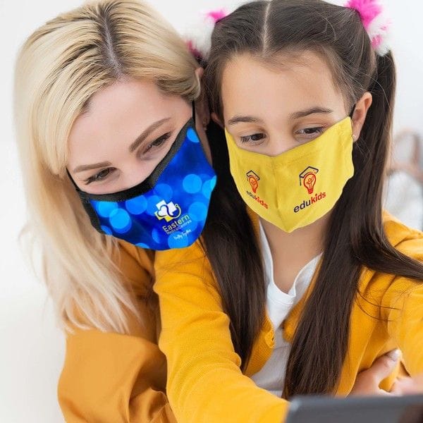 A mum and daughter wearing deluxe fabric facemask with custom branding