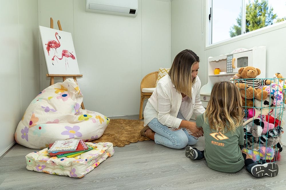 A mum and son playing in toy room