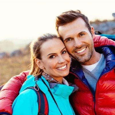 Young couple smiling while hiking
