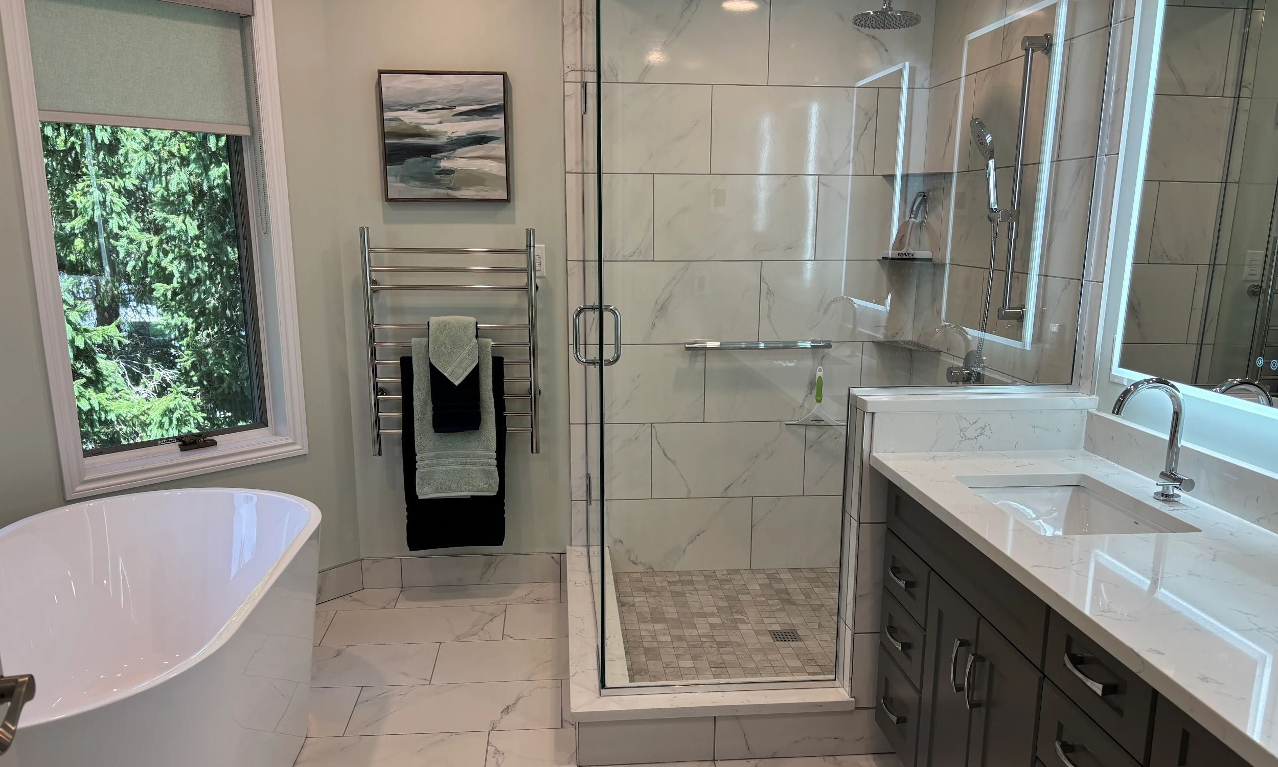 This bathroom includes a jacuzzi tub, stand up shower and double vanity with backlit mirrors for incredible ambiance