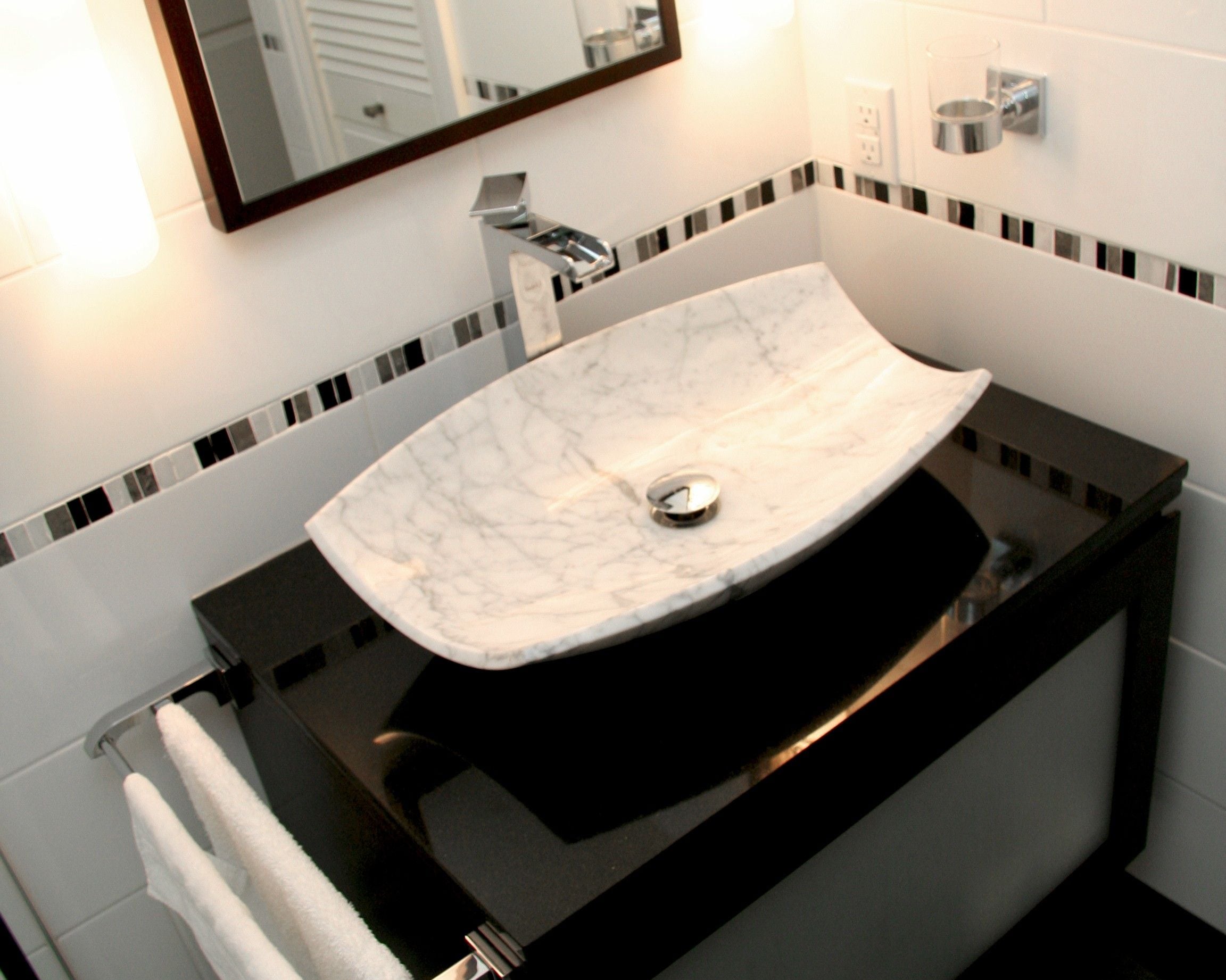 Stylishly renovated bathroom with floating sink and new tile