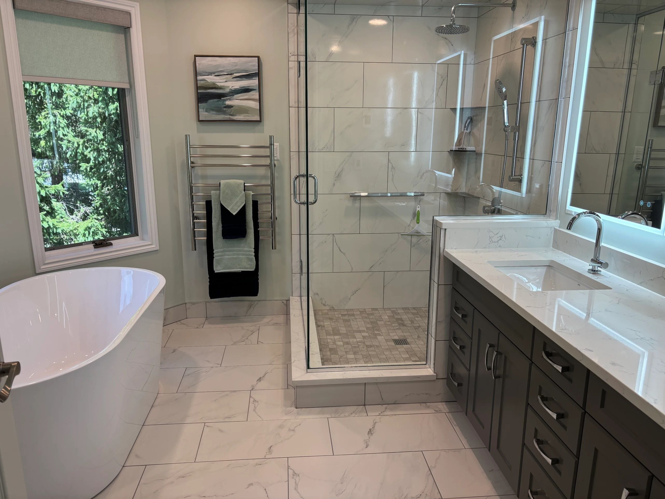 Awesome bathroom renovation by Family Home Improvements This bathroom renovations features a freestanding corner shower unit, expansive countertops and a standalone soaking tub