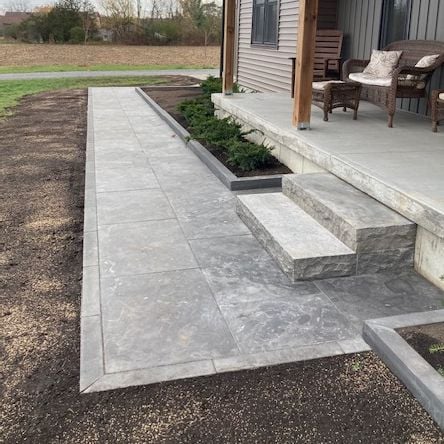 Silver antique limestone  flagstone, onyx curb, Japanese yew with natural stone steps to match