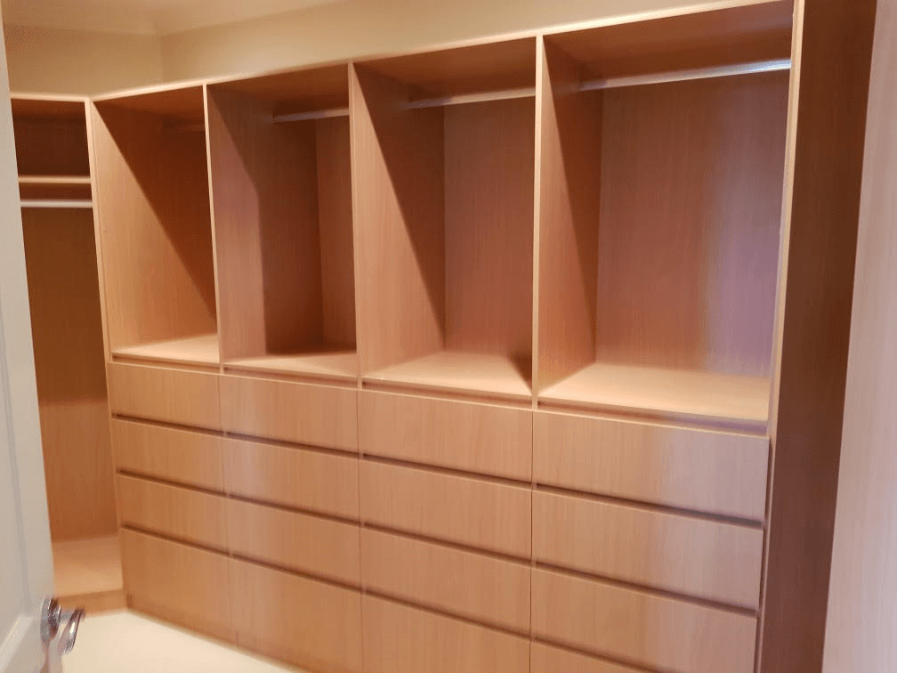 Full colour WIR using DR Henderson Sonova Beech. Full colour backing. Raised lip drawer fronts, tilt forward laundry hamper. Designer to suit angled wall for maximum storage