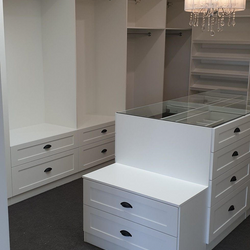 White WIR with shaker profile drawer fronts. Centre Island with seat. Sloping shoe racks with upstands and slide out scarf cupboard