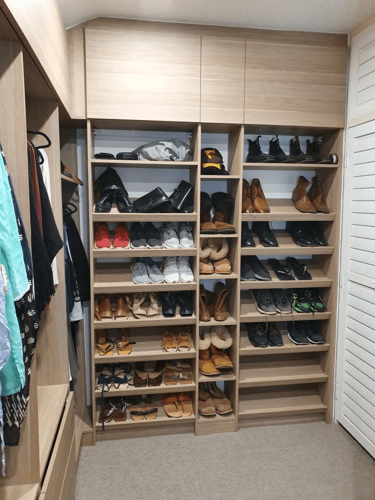 WIR using Polytec Maison Oak Matt. Overhead hinged doors. Sloping shoe racks with upstands