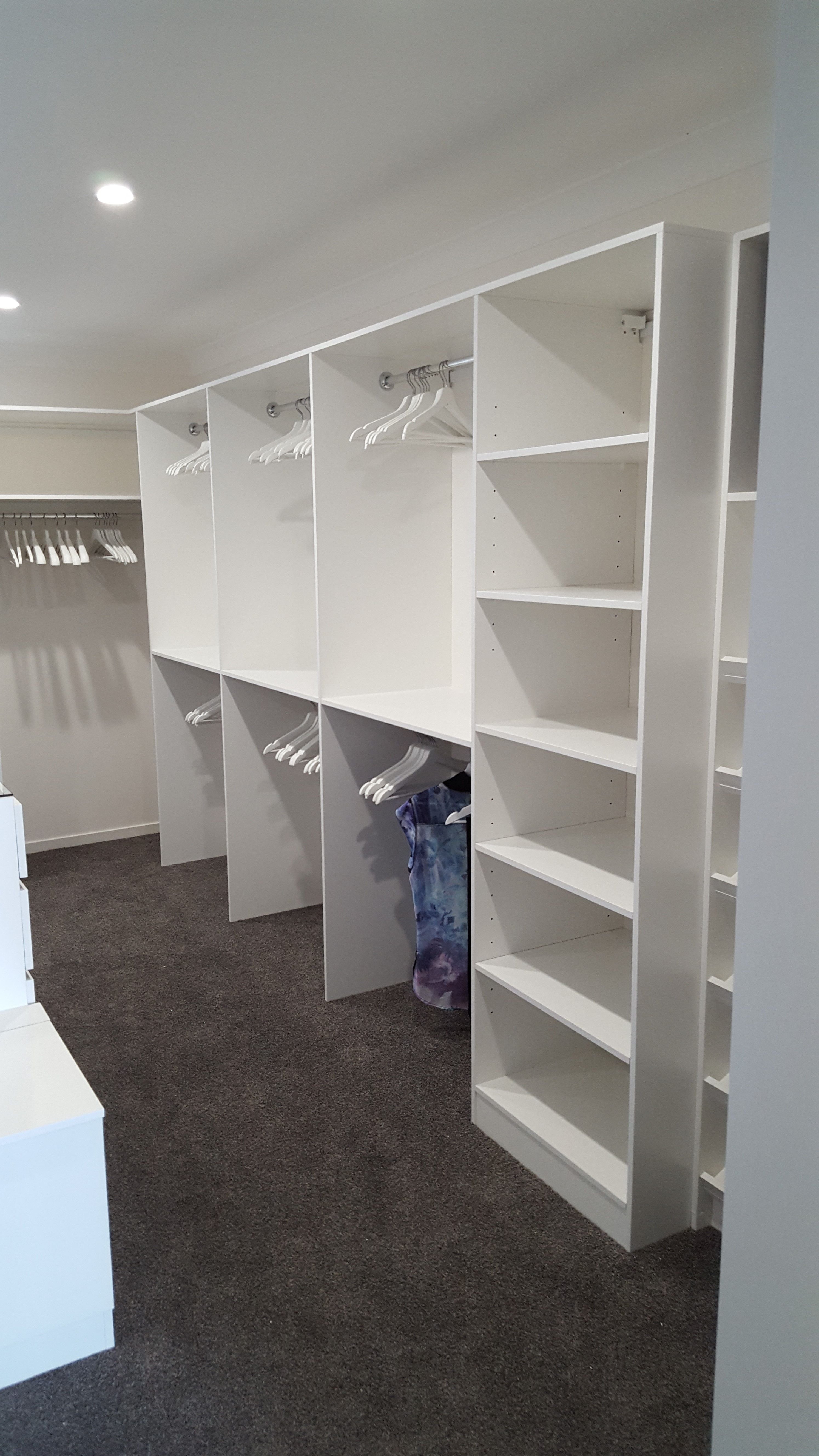 WIR using White HMR Melamine, centre island with 6mm toughened clear glass top. No backing. Open drawer fronts and white 32mm diameter hanging rail