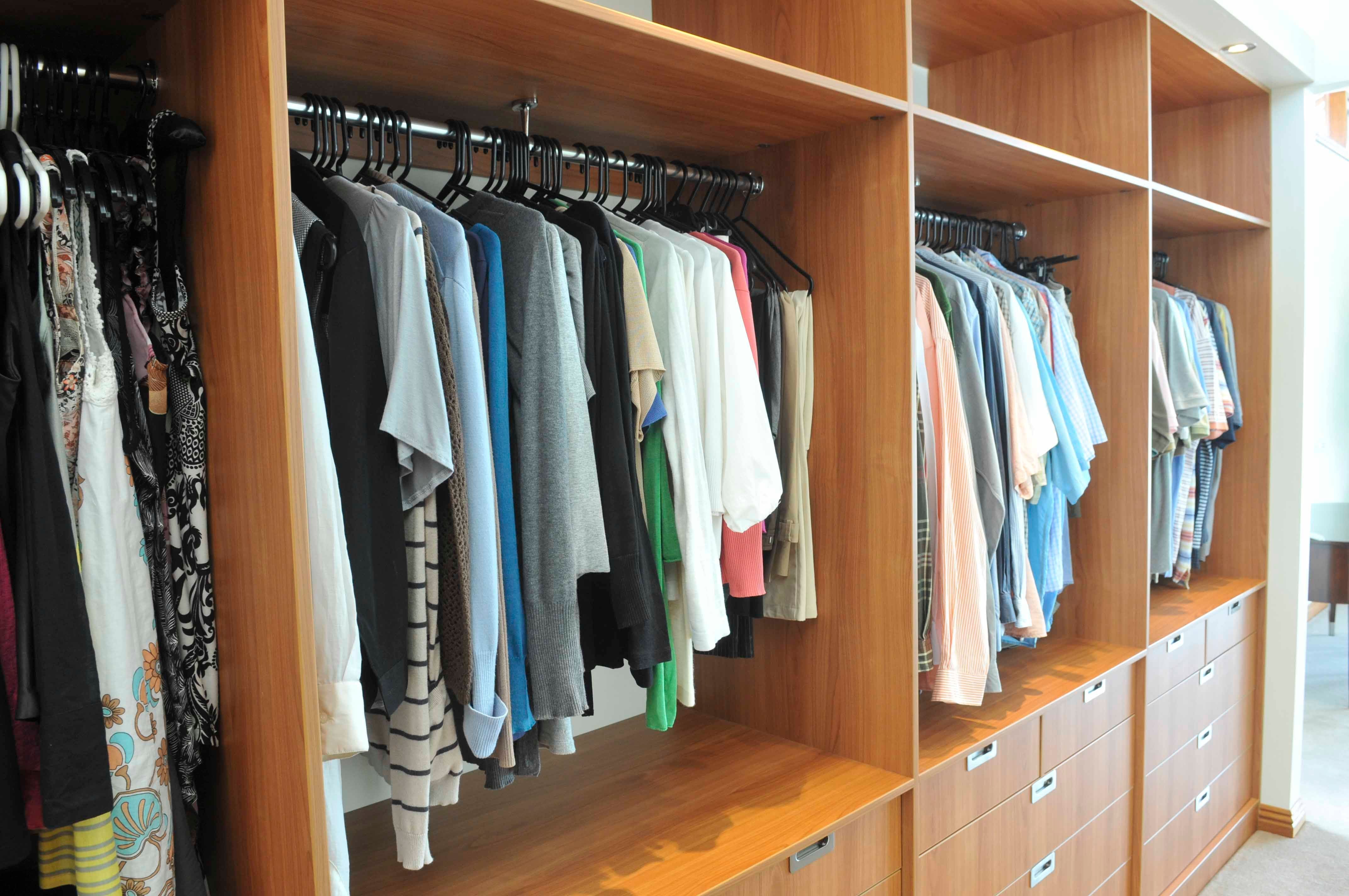 Walk in robe using Laminex Country Cherry. Floating shelves. Overhanging bulkhead with downlights. Wall mirror with border. Recessed handle drawers