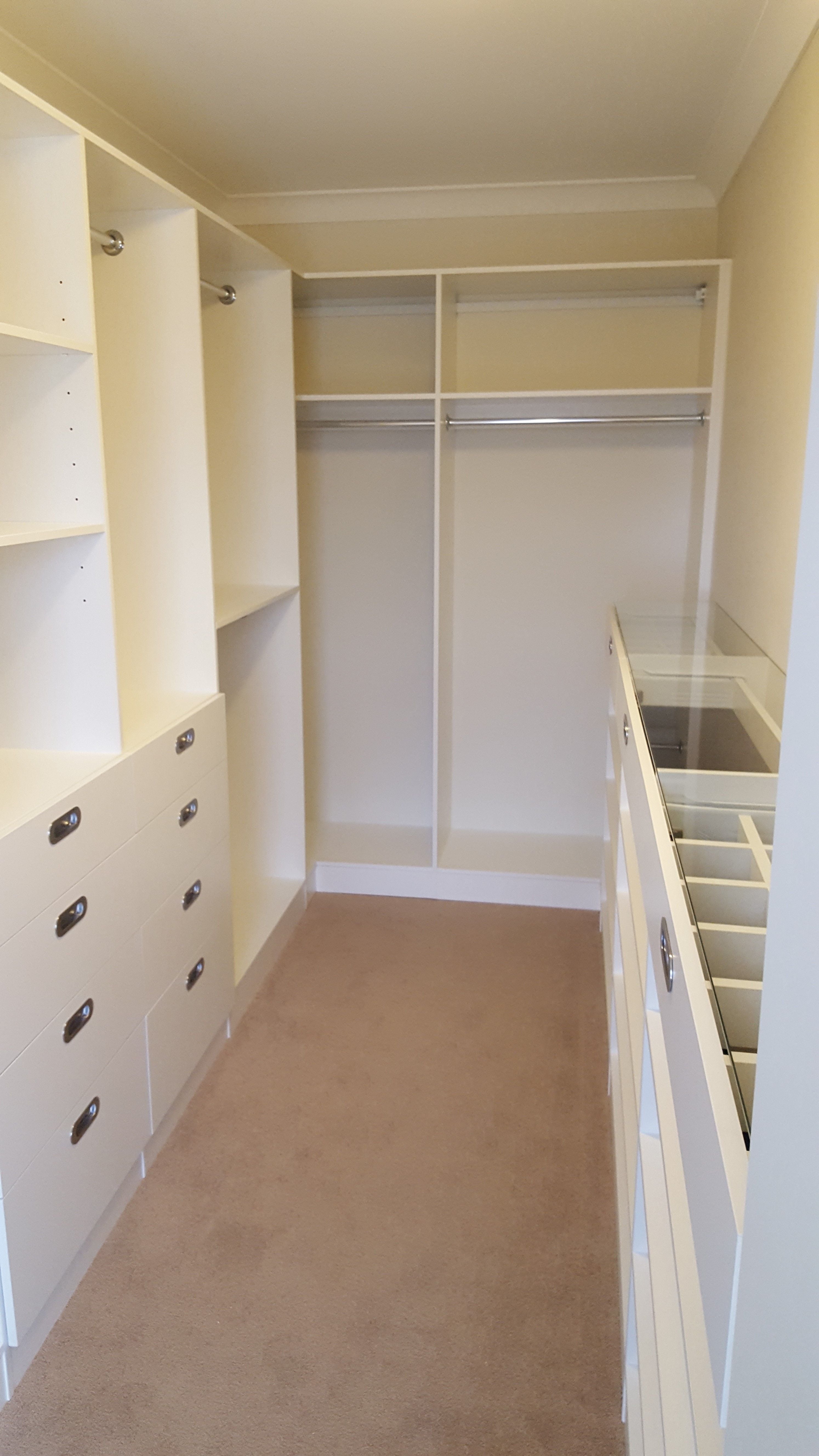 White WIR. Drawer fronts with recessed handle. 6mm toughened clear glass top. Top drawers with dividers. Flat shoe shelving