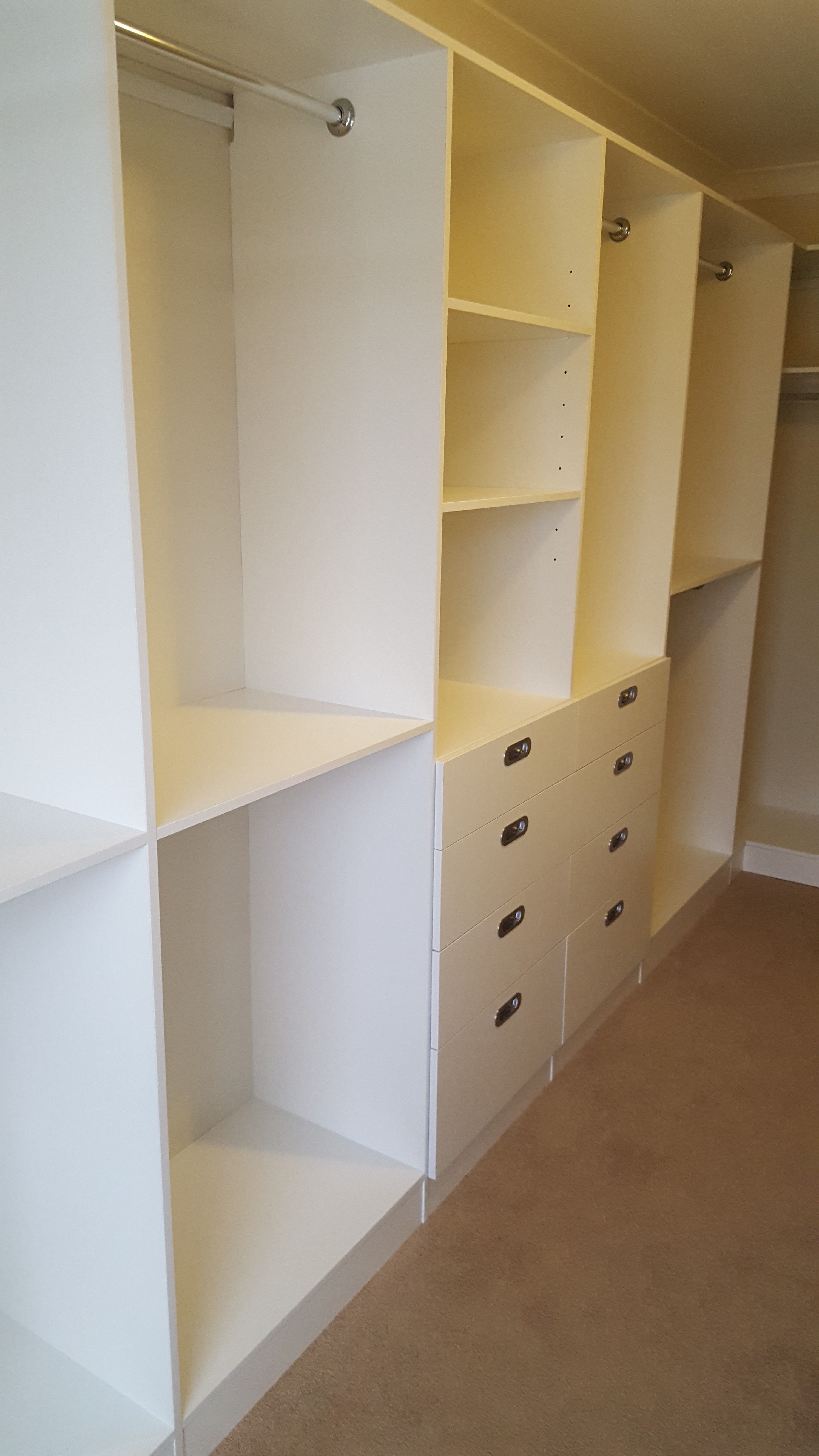 White WIR. Drawer fronts with recessed handle. 6mm toughened clear glass top. Top drawers with dividers. Flat shoe shelving