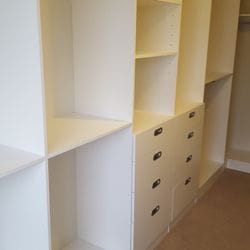 White WIR. Drawer fronts with recessed handle. 6mm toughened clear glass top. Top drawers with dividers. Flat shoe shelving
