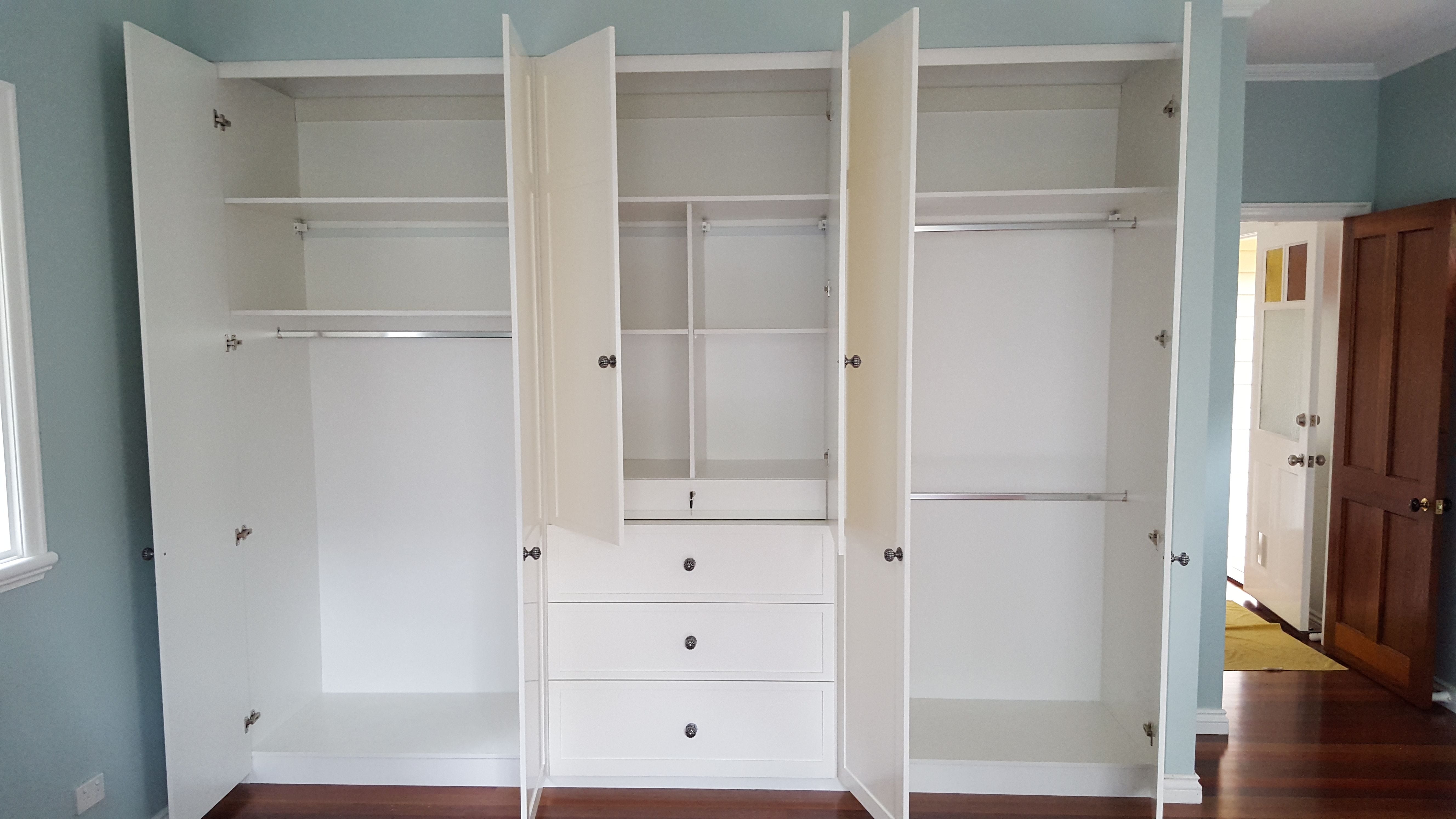 Built in robe using White HMR Melamine with chrome hanging rail, drawers, recessed drawer for jewellery tray and shelving