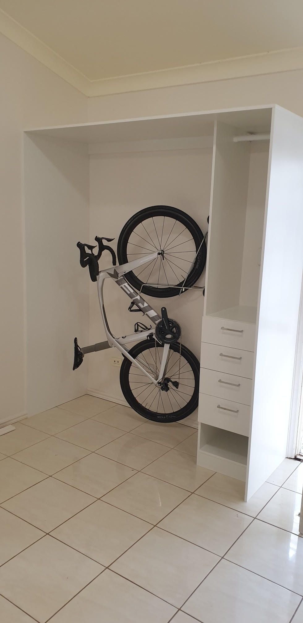 Garage storage for this keen cyclist. Steady rack for bike, rail for jerseys, shelf for helmets and drawer for gloves, socks, repair kits etc.