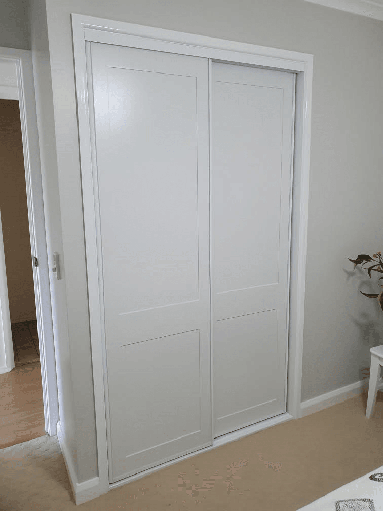 Fully framed shaker profile sliding doors. 2 pack painted finish. Dias White aluminum trims & track