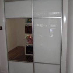 1 set of 2 fully framed divider doors. Combination of white glass & silver mirror glass inserts. Dias Satin silver trims, dividers, top & bottom tracks