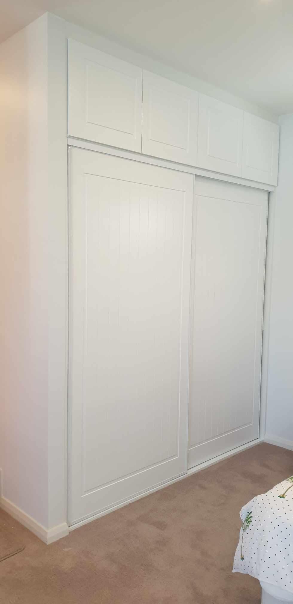 1 set of 2 fully framed "York" profile siding doors with 2 sets of 2 overhead hinged doors. 2 pack painted finish. Dias white aluminum trims & tracks
