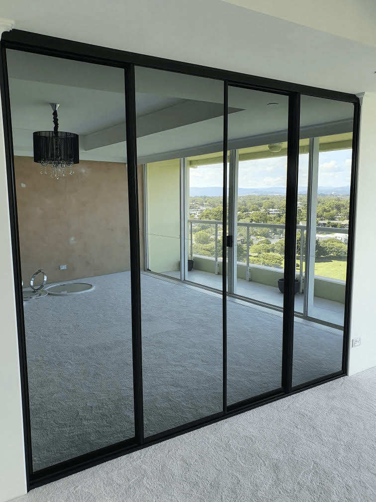 1 set of 4 fully framed 4mm vinyl backed dark grey mirror sliding doors. Dias black aluminum trims & tracks