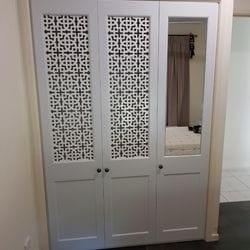 Hinged doors with 2 pack painted finish. Profile bottom panel and powder coated decorative screen inserts and single mirror insert