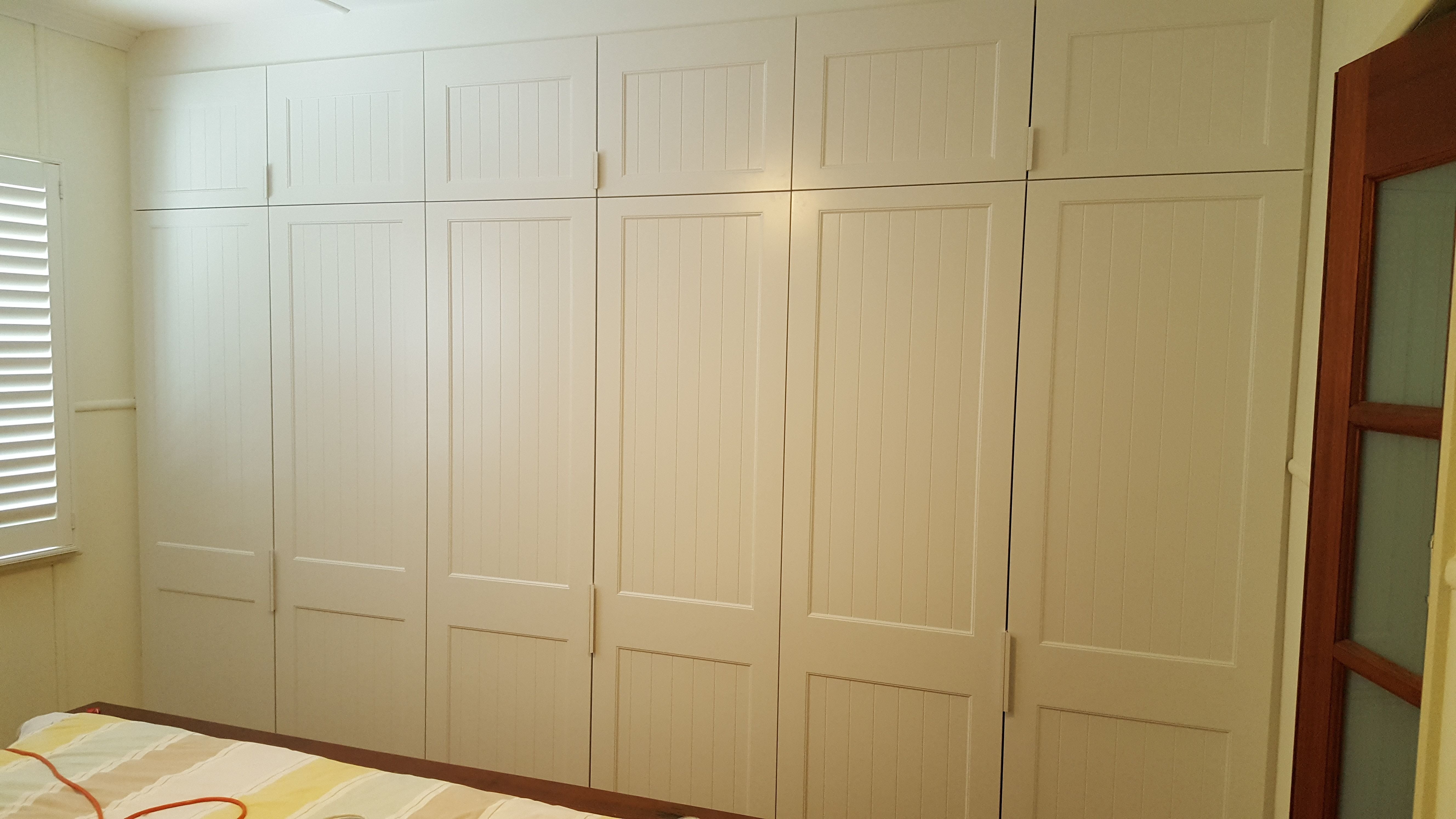 6 sets of 2 hinged doors with Profile 2 VJ panels and 2 pack painted finish. White 100mm finger pull handles