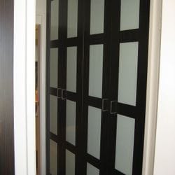 2 sets of 2 hinged doors using Polytec "Black Wenge Matt" MR MDF with opaque white glass inserts. 96mm Satin Silver Luca handles. 100mm bulkhead