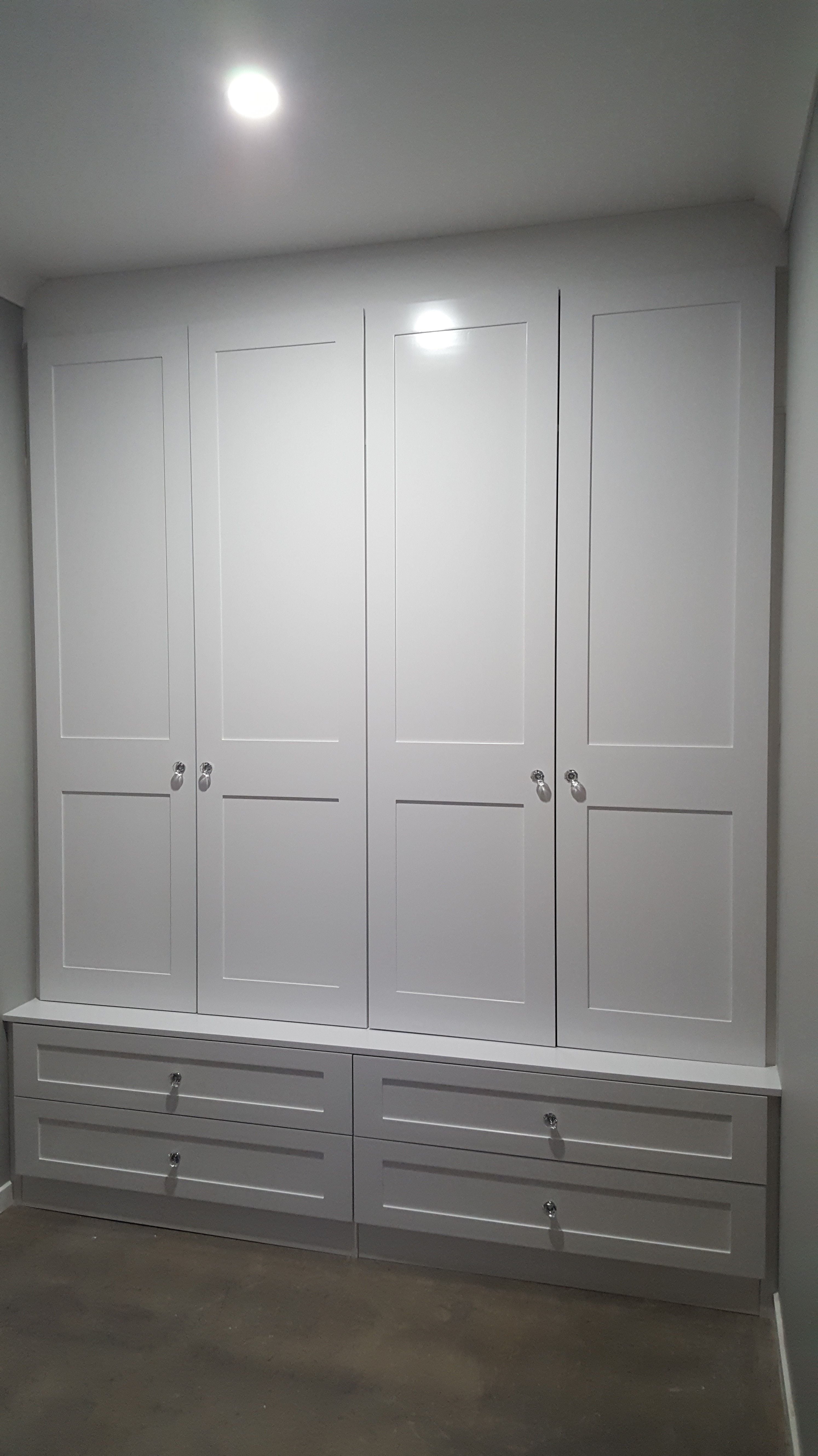 Mud room with shaker profile hinged doors which are stepped back from bottom drawers creating a ledge. 2 pack painted finish. Crystal knobs