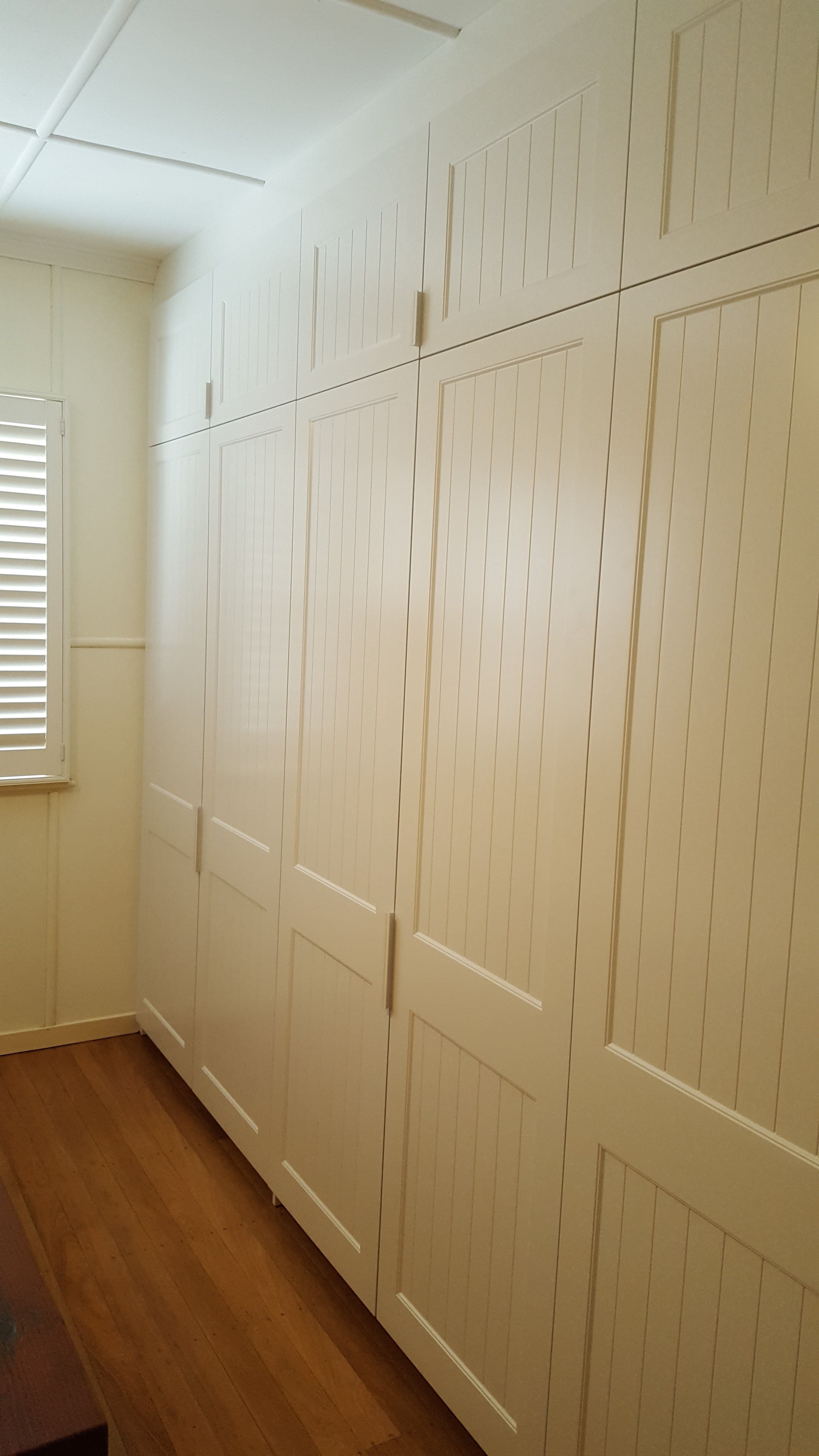 3 sets of 2 hinged doors with profile 2 & VJ insert. 2 pack painted finish. 100mm white finger pull handles. 100mm bulkhead