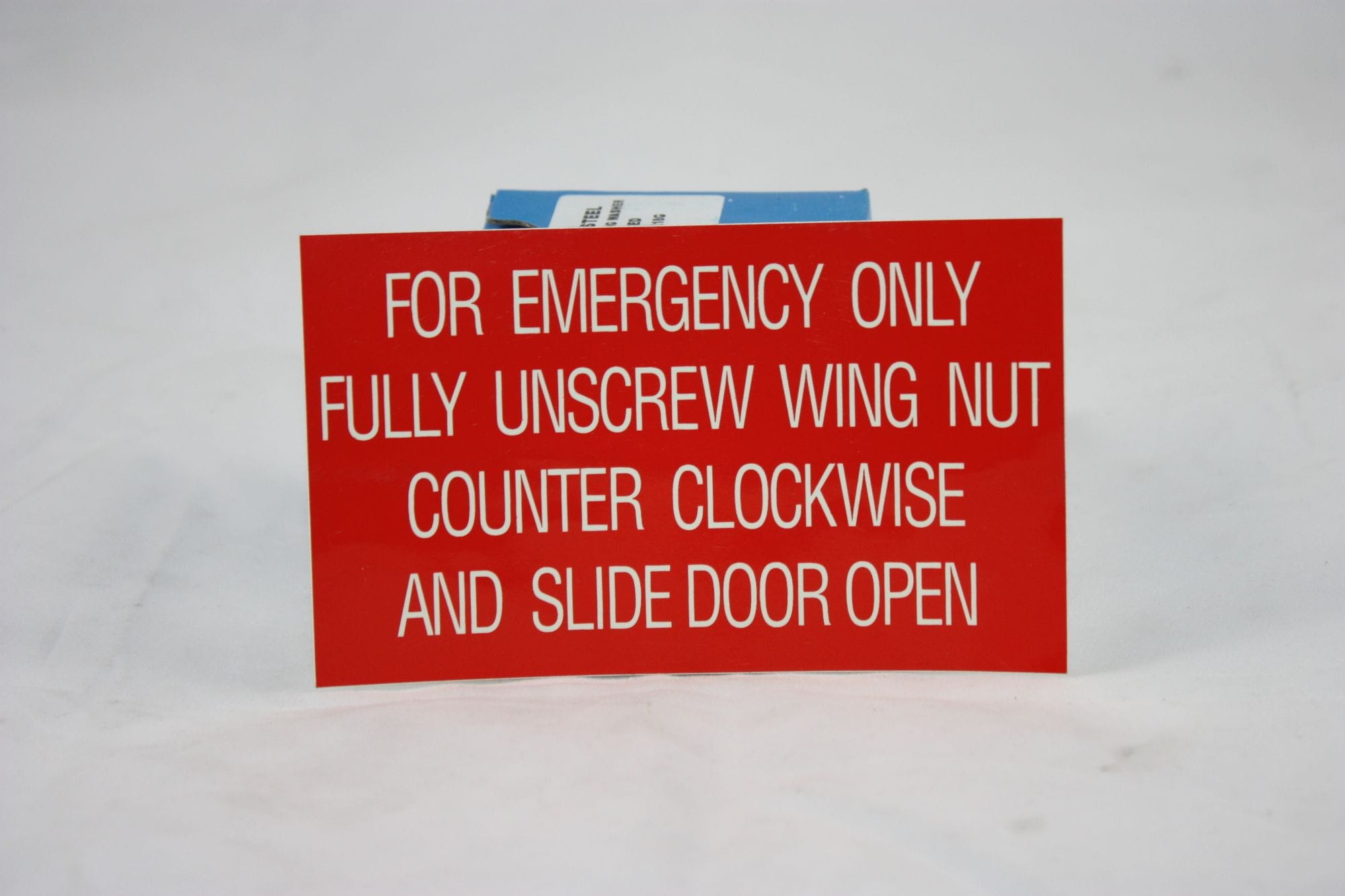 Fluorescent Emergency Sticker - Unscrew wing nut and slide door open