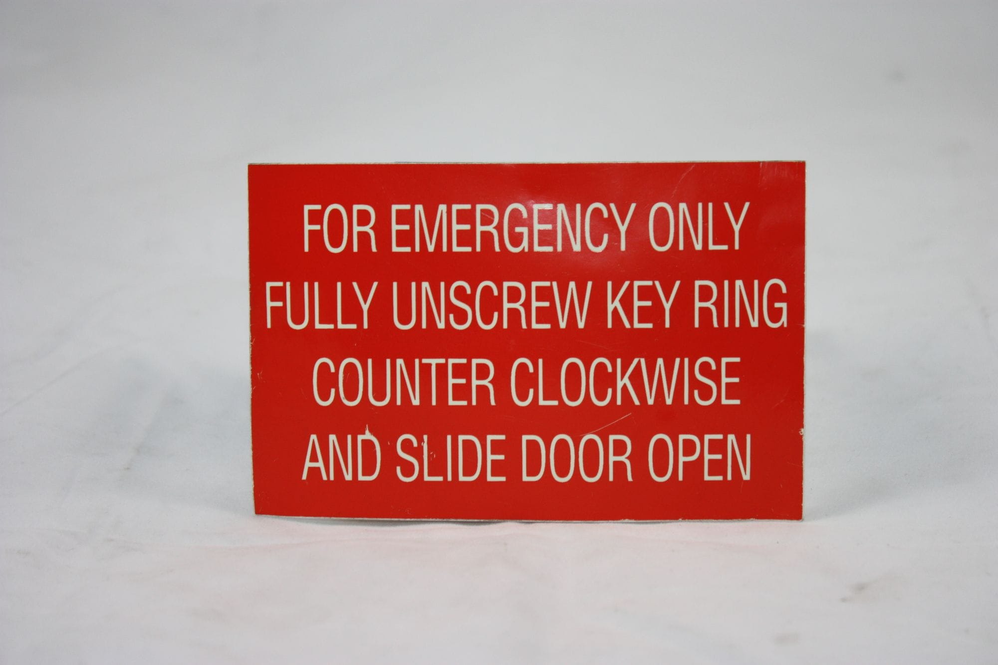 Fluorescent Emergency Sticker - Unscrew key ring and slide door open
