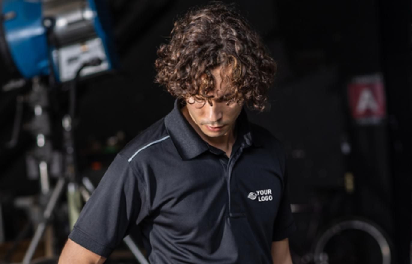 Technician wearing a branded Portwest polo shirt with logo placement, representing a presentable service department uniform