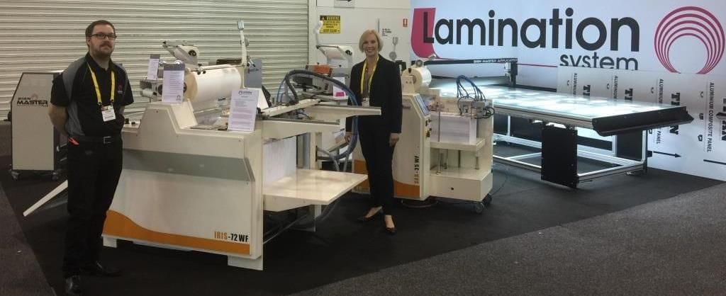 Dylan & Sarah standing next to Automatic Laminators on our stand at the PacPrint trade show