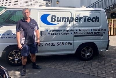 Bumpertech technician standing outside a mobile repair van