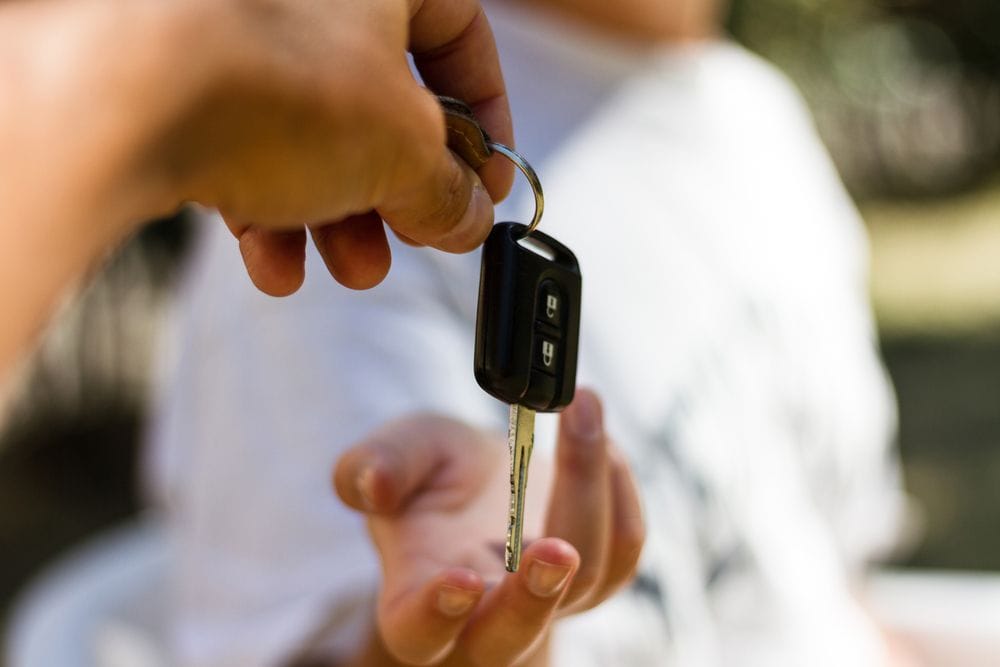 Young Woman Receives A Rental Car Key