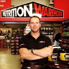BODY BUILDER FLEXES MUSCLES IN BUSINESS