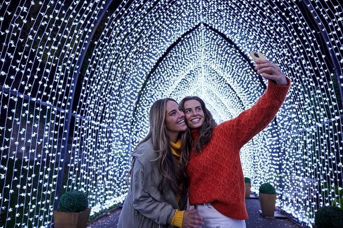 Attendees take a selfie at the Lightscape display at the Royal Botanic Gardens.