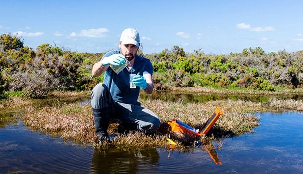 Environmental consultant testing water and field monitoring