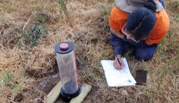 Environmental consultant testing water and field monitoring