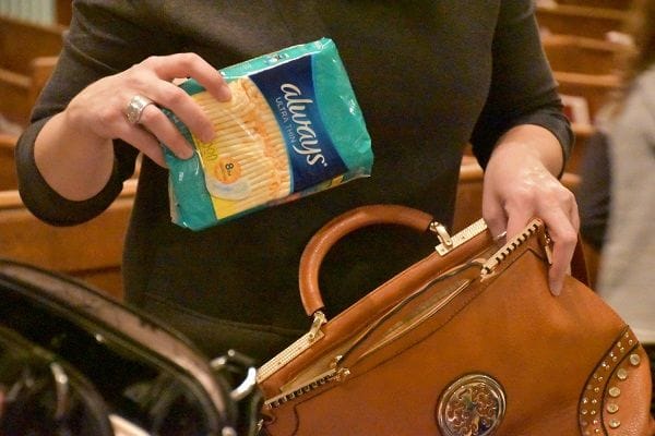 purses filled with tampons, pads and feminine hygiene products