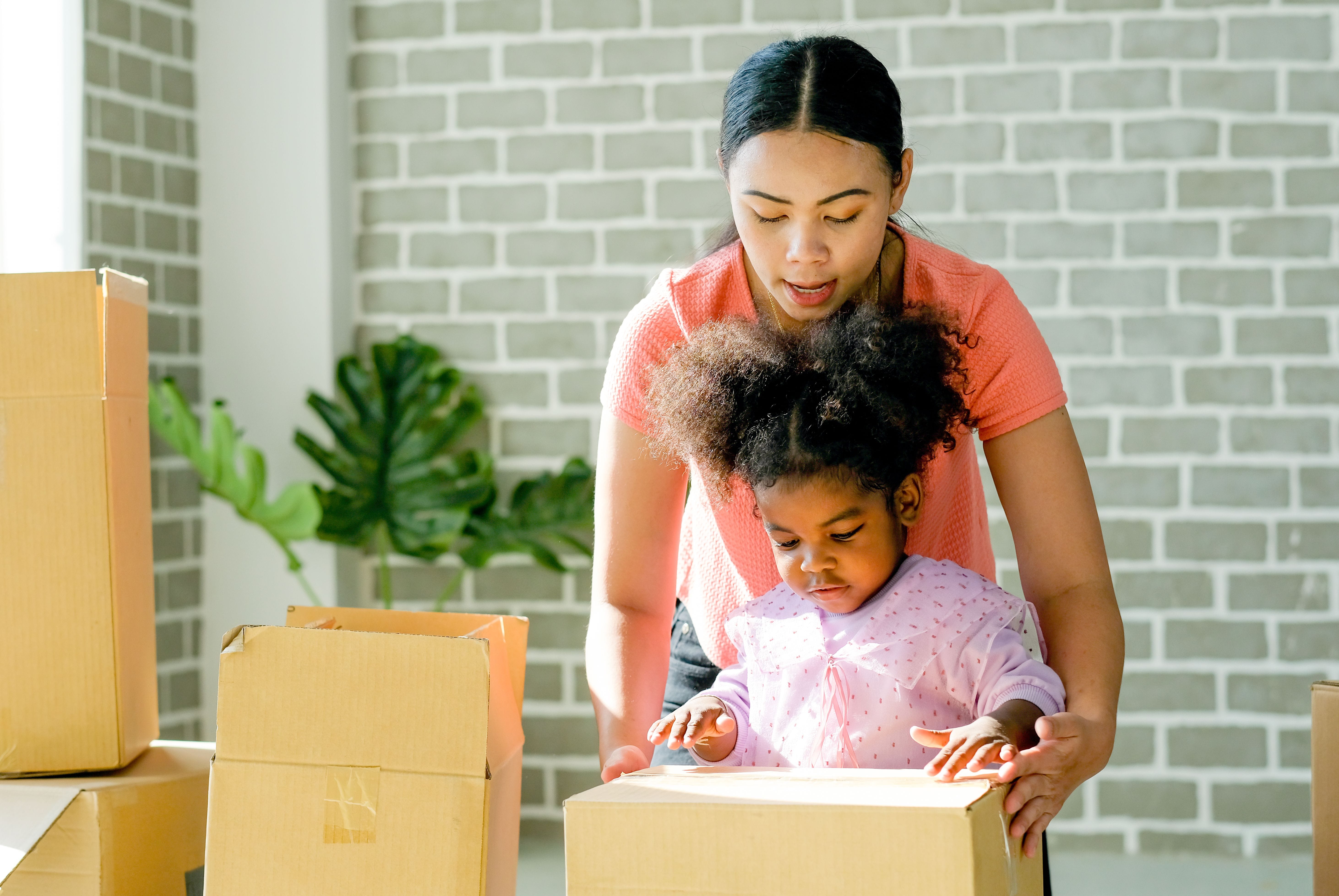 A woman and her daughter pack up boxes for their cross country move