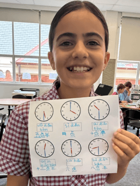 Learning Mandarin Through Real-World Concepts Primary students learning to tell the time in Mandarin using interactive activities