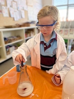 Student conducting a science experiment as part of the STEAM inquiry unit