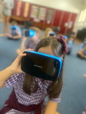 Immersive learning with virtual reality Student exploring a virtual environment using a VR headset during a technology session