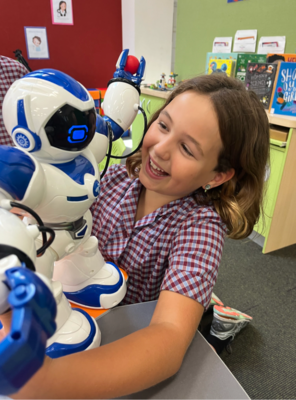 Exploring robotics Primary student engaging with a robot during a STEAM lesson