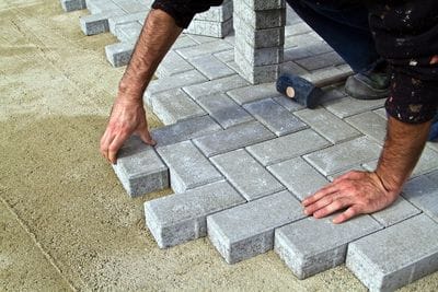 Landscape contractor laying pavers