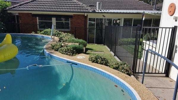 raked-black-tubular-pool-fence---timber-paling-boundary