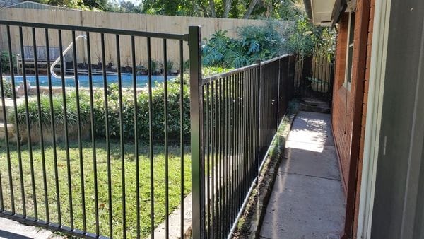 raked-black-tubular-pool-fence---timber-paling-boundary
