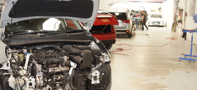 3 cars and a man BRB Smash Repairs workshop is clean with modern equipment