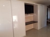 Robe either side of TV with Gloss white MR MDF sliding doors